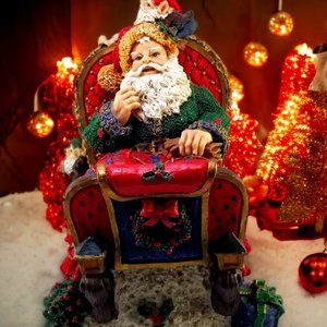 Santa in a Red Sleight Bed Resin Holiday Décor with Elves, Presents, And Toys